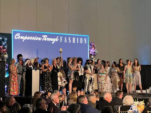 Models wearing eco-friendly runway designs created from salon waste at Compassion Through Fashion event